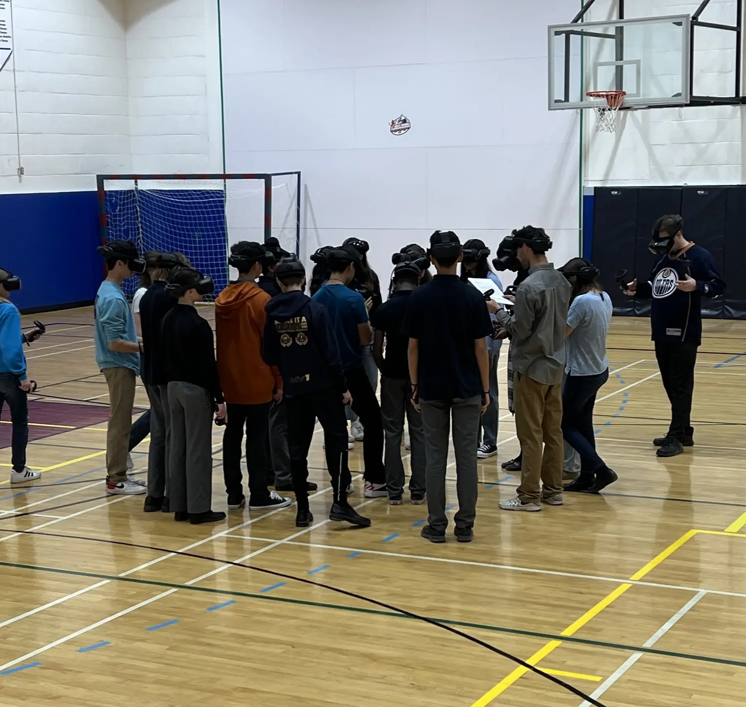 Students and educators taking part in a VR session in a gym