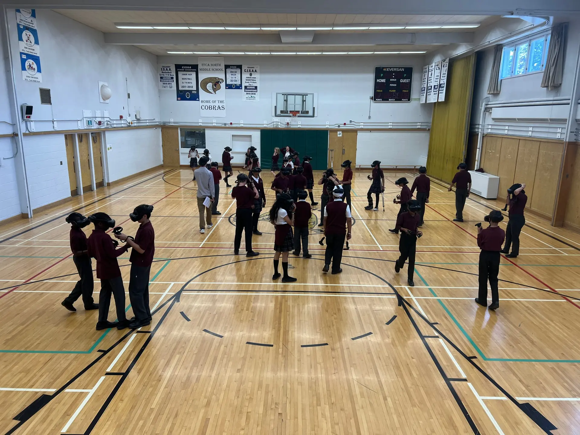 Photo of kids in headsets in the gym